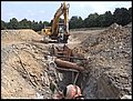 ER 1500-1 sideways cutter heads with shovel on a trenching site